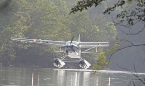 Dramatization of a float plane with a chunk of wing missing.