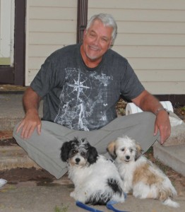 Mark with the two puppies.
